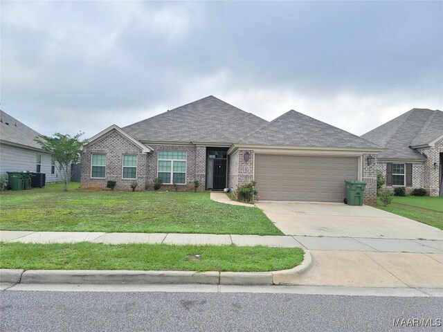 1008 Overture Dr, Montgomery, AL 36117 - single story home featuring brick siding, a garage, a front lawn, and driveway
