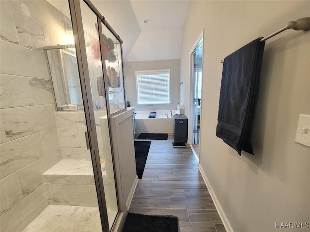 1008 Overture Dr, Montgomery, AL 36117 - full bathroom with a garden tub, a shower stall, lofted ceiling, and wood finished floors