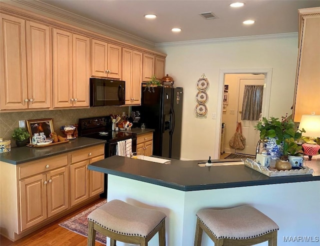 5650 Ash Grove Ct, Montgomery, AL 36116 - kitchen featuring black appliances, dark countertops, a breakfast bar area, backsplash, and crown molding