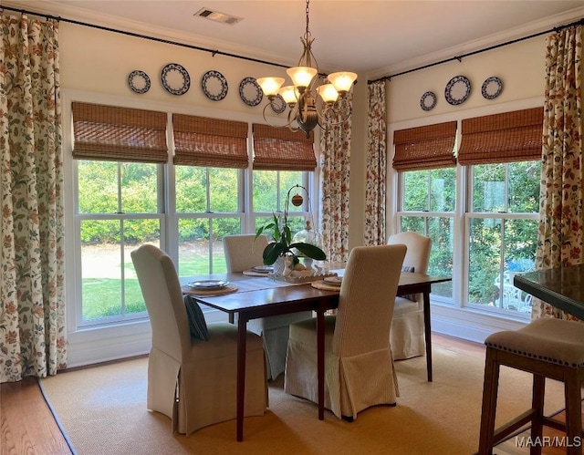 5650 Ash Grove Ct, Montgomery, AL 36116 - dining area with a chandelier, crown molding, and light wood-style floors