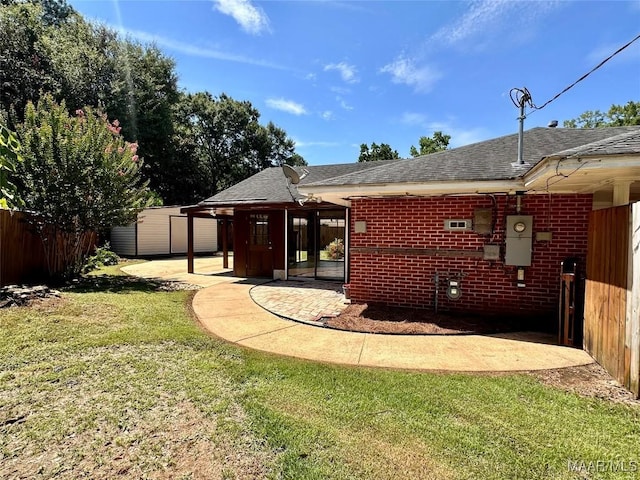 3551 Dalraida Pkwy, Montgomery, AL 36109 - rear view of property with roof with shingles, brick siding, a patio, and a storage shed