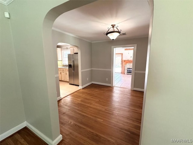 3551 Dalraida Pkwy, Montgomery, AL 36109 - spare room featuring light wood-style floors, ornamental molding, and arched walkways