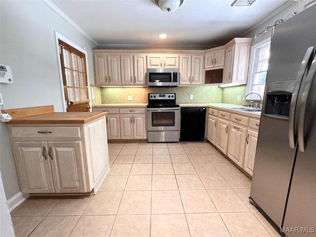 3551 Dalraida Pkwy, Montgomery, AL 36109 - kitchen featuring stainless steel appliances, light countertops, light tile patterned floors, backsplash, and crown molding