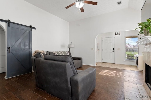 6526 Ridgeview Ln, Montgomery, AL 36116 - living room with a barn door, lofted ceiling, arched walkways, a ceiling fan, and wood finished floors