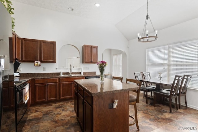 6526 Ridgeview Ln, Montgomery, AL 36116 - kitchen featuring black electric range oven, arched walkways, stone finish floors, a kitchen breakfast bar, and high vaulted ceiling