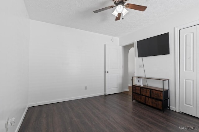 6526 Ridgeview Ln, Montgomery, AL 36116 - unfurnished living room featuring wood finished floors, a textured ceiling, ceiling fan, and arched walkways