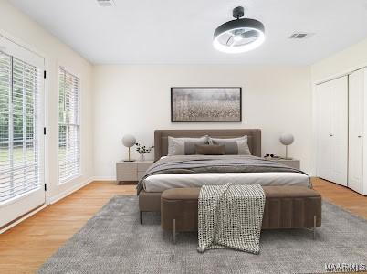 1243 Highpoint Rd, Montgomery, AL 36109 - bedroom with wood finished floors, access to outside, and a closet