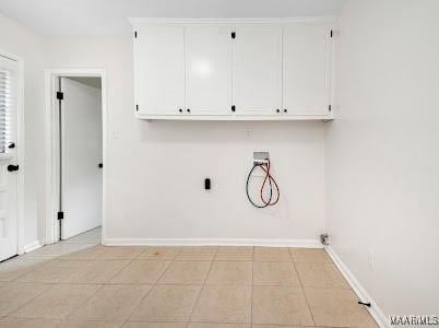 1243 Highpoint Rd, Montgomery, AL 36109 - laundry room featuring cabinet space and light tile patterned floors