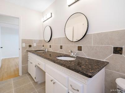 1243 Highpoint Rd, Montgomery, AL 36109 - full bath with tile walls, double vanity, and tile patterned flooring