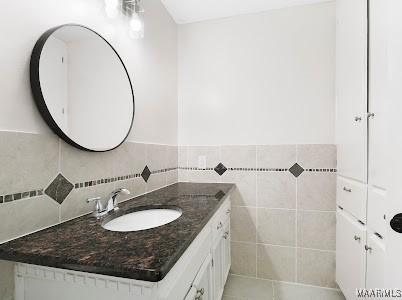 1243 Highpoint Rd, Montgomery, AL 36109 - bathroom featuring vanity, tile walls, and wainscoting
