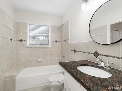 1243 Highpoint Rd, Montgomery, AL 36109 - full bath with vanity, tub / shower combination, tile walls, and decorative backsplash