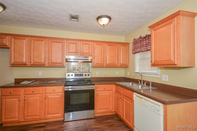 134 Taylor Hill Dr, Wetumpka, AL 36092 - kitchen with electric range, white dishwasher, under cabinet range hood, dark countertops, and a textured ceiling