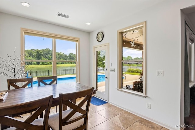 9185 Brenham Ct, Montgomery, AL 36117 - dining space featuring light tile patterned flooring, recessed lighting, a water view, and rail lighting
