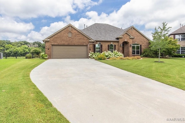 9185 Brenham Ct, Montgomery, AL 36117 - view of front facade with brick siding, driveway, a garage, and roof with shingles