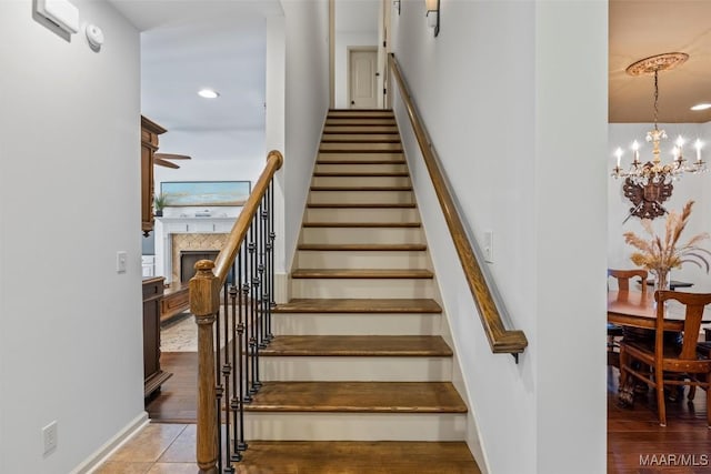 9185 Brenham Ct, Montgomery, AL 36117 - staircase with a chandelier, a fireplace, and recessed lighting