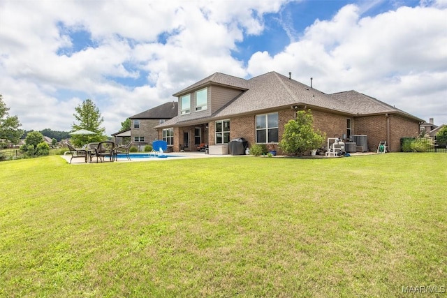9185 Brenham Ct, Montgomery, AL 36117 - rear view of house featuring brick siding, a yard, a patio area, and roof with shingles