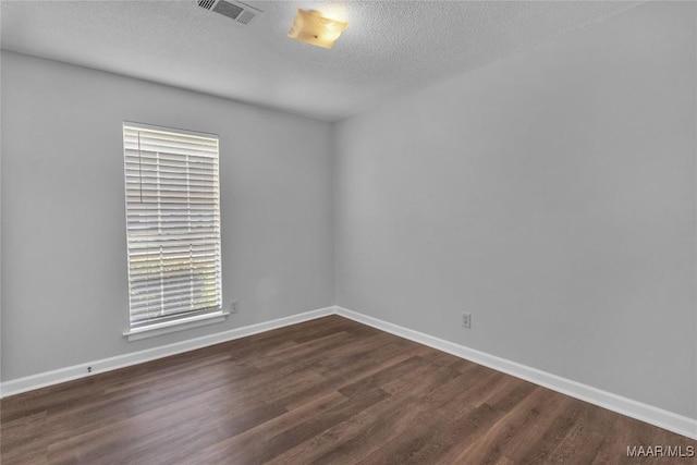 3213 Milan Dr, Montgomery, AL 36109 - unfurnished room featuring dark wood-style floors and a textured ceiling