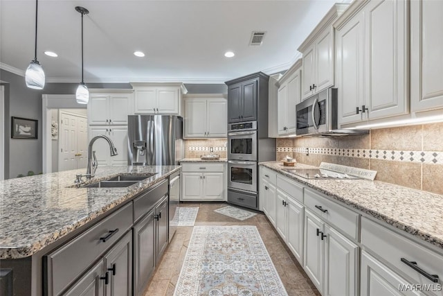 378 Winding Wood Dr, Wetumpka, AL 36093 - kitchen with stainless steel appliances, crown molding, decorative backsplash, decorative light fixtures, and light stone countertops