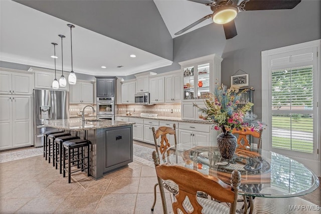 378 Winding Wood Dr, Wetumpka, AL 36093 - kitchen with appliances with stainless steel finishes, a ceiling fan, healthy amount of natural light, backsplash, and crown molding