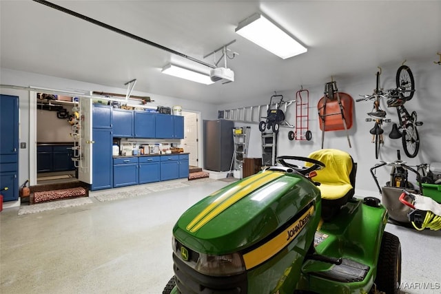 378 Winding Wood Dr, Wetumpka, AL 36093 - garage with refrigerator and a garage door opener