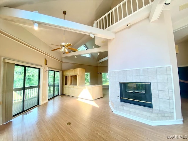 400 Millcreek Rd, Wetumpka, AL 36093 - unfurnished living room with high vaulted ceiling, beamed ceiling, a ceiling fan, wood finished floors, and healthy amount of natural light