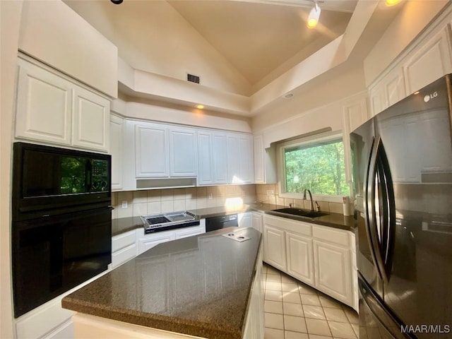 400 Millcreek Rd, Wetumpka, AL 36093 - kitchen featuring black appliances, backsplash, white cabinets, a kitchen island, and light tile patterned floors