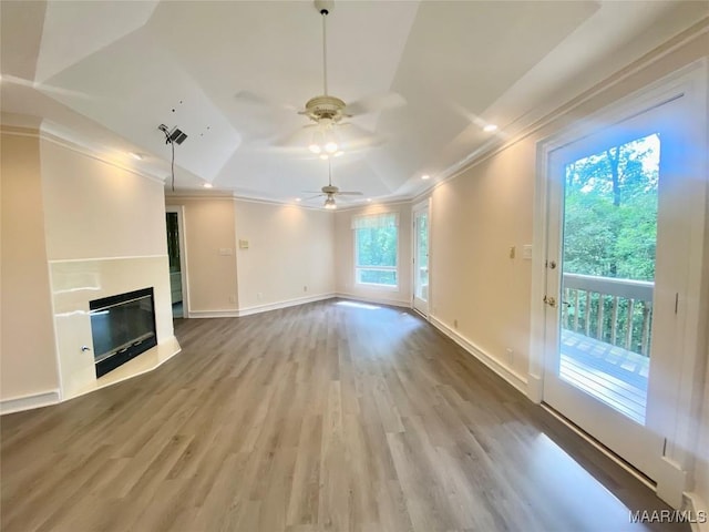 400 Millcreek Rd, Wetumpka, AL 36093 - unfurnished living room with crown molding, wood finished floors, a tray ceiling, ceiling fan, and a glass covered fireplace