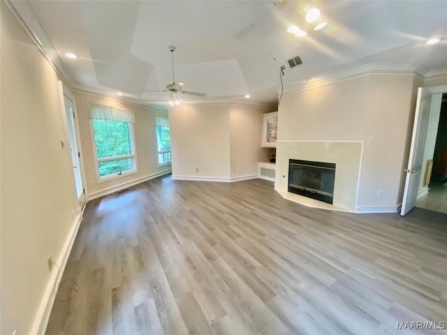 400 Millcreek Rd, Wetumpka, AL 36093 - unfurnished living room with a ceiling fan, crown molding, wood finished floors, a premium fireplace, and a raised ceiling
