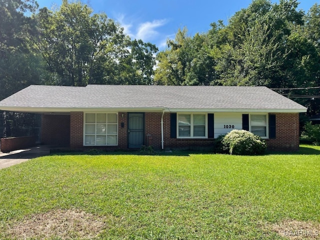 1030 Lynwood Dr, Montgomery, AL 36111 - single story home featuring a front yard, brick siding, a carport, and roof with shingles