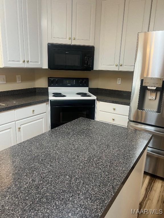 9324 Bristlecone Dr, Montgomery, AL 36117 - kitchen with stainless steel fridge, black microwave, electric range, and white cabinets