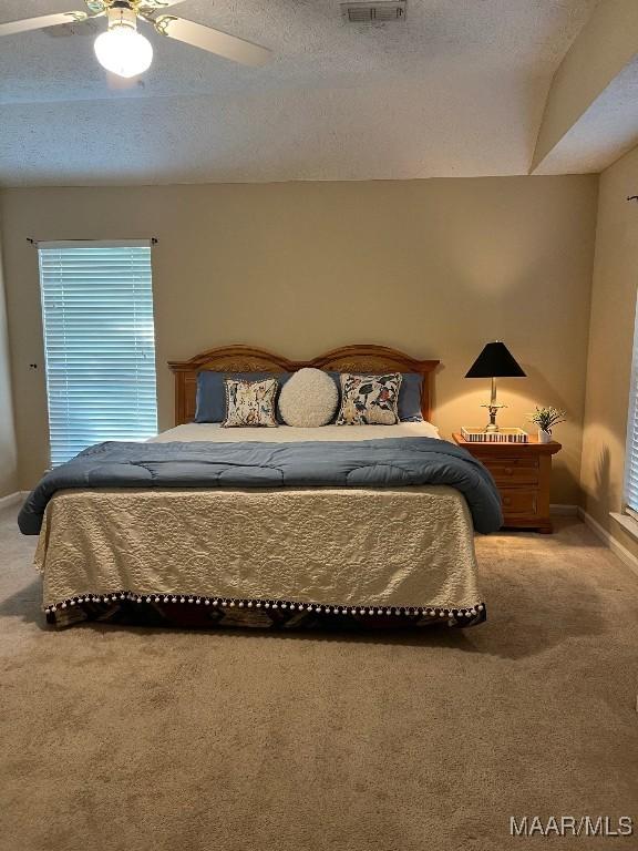 9324 Bristlecone Dr, Montgomery, AL 36117 - carpeted bedroom featuring a textured ceiling and a ceiling fan
