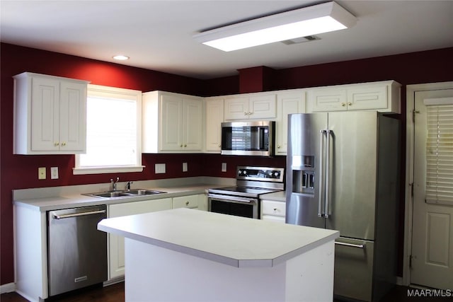 2108 Halcyon Downs Loop, Montgomery, AL 36117 - kitchen featuring appliances with stainless steel finishes, white cabinetry, light countertops, a kitchen island, and recessed lighting