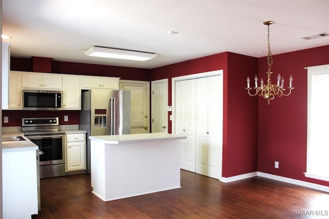 2108 Halcyon Downs Loop, Montgomery, AL 36117 - kitchen featuring appliances with stainless steel finishes, light countertops, a chandelier, white cabinets, and dark wood-type flooring