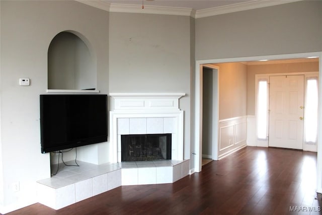 2108 Halcyon Downs Loop, Montgomery, AL 36117 - unfurnished living room featuring wood finished floors, crown molding, a fireplace, and a wainscoted wall