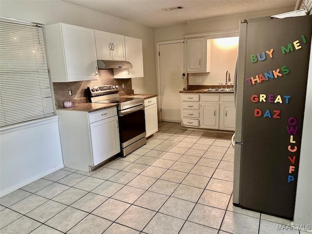 174 Weldon Rd, Tallassee, AL 36078 - kitchen with stainless steel appliances, white cabinets, backsplash, under cabinet range hood, and light tile patterned floors