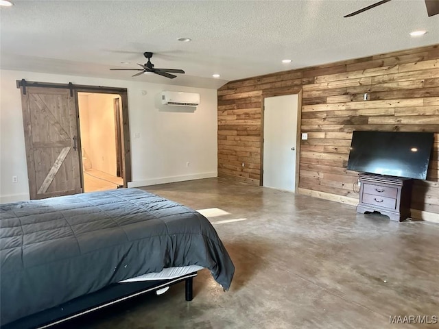 174 Weldon Rd, Tallassee, AL 36078 - bedroom featuring a wall mounted AC, a barn door, wood walls, recessed lighting, and a textured ceiling