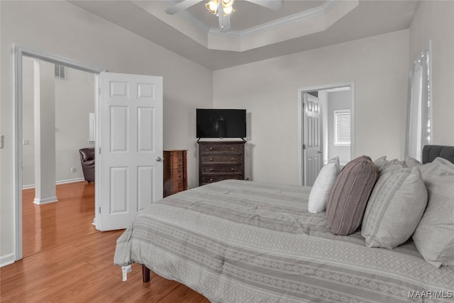 6779 Overview Dr, Montgomery, AL 36117 - bedroom with light wood finished floors, a tray ceiling, ornamental molding, and ceiling fan
