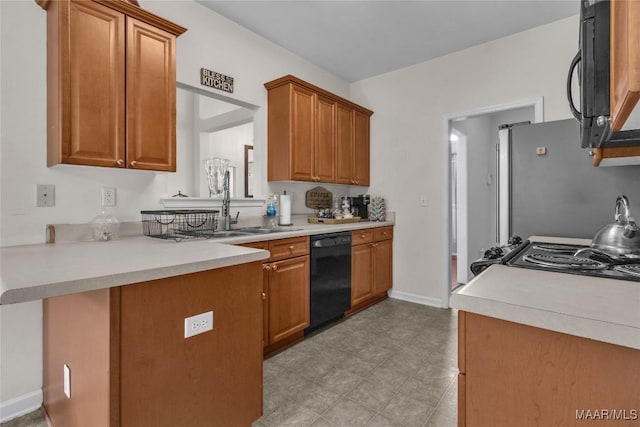 6779 Overview Dr, Montgomery, AL 36117 - kitchen featuring black appliances, light countertops, and brown cabinets