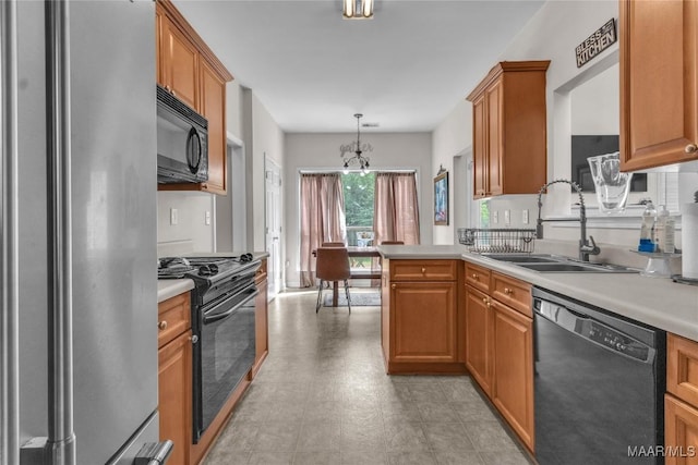 6779 Overview Dr, Montgomery, AL 36117 - kitchen featuring black appliances, light countertops, and brown cabinetry