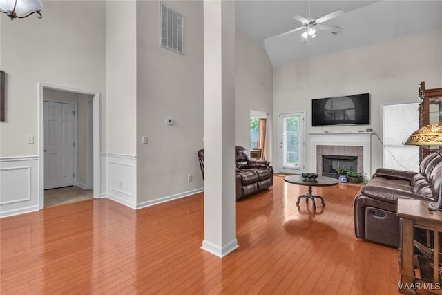 6779 Overview Dr, Montgomery, AL 36117 - living room featuring high vaulted ceiling, hardwood / wood-style flooring, ceiling fan, a fireplace, and a wainscoted wall