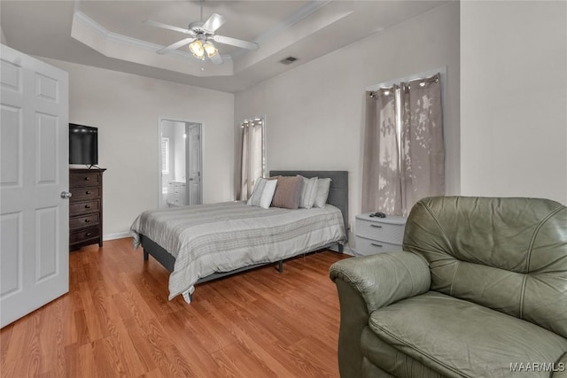 6779 Overview Dr, Montgomery, AL 36117 - bedroom with a raised ceiling, wood finished floors, crown molding, ensuite bathroom, and ceiling fan