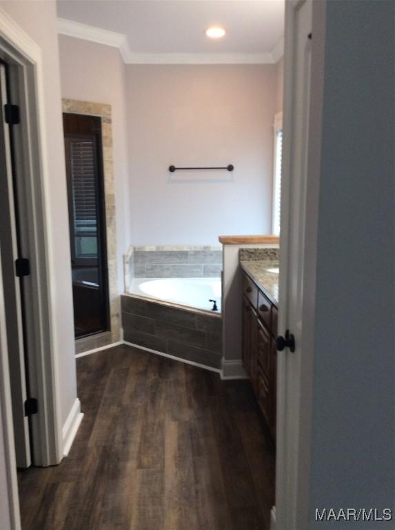 101 Regans Way S, Deatsville, AL 36022 - bathroom with vanity, a garden tub, crown molding, wood finished floors, and recessed lighting
