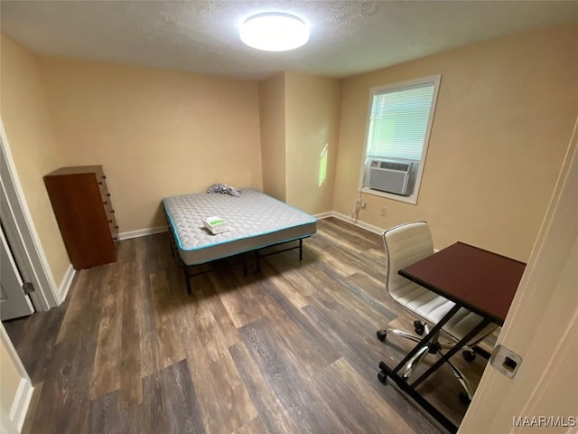 1010 New St, Tuskegee, AL 36083 - bedroom featuring cooling unit, wood finished floors, and a textured ceiling