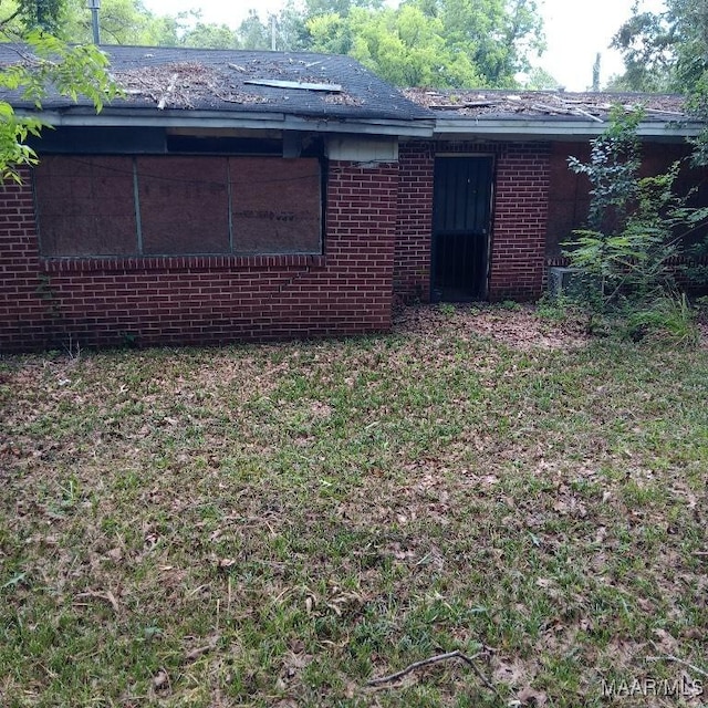 629 Doris St, Montgomery, AL 36105 - back of house featuring brick siding and a yard