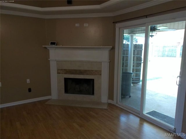213 Foxdale Rd, Millbrook, AL 36054 - unfurnished living room featuring wood finished floors, ornamental molding, and a tile fireplace