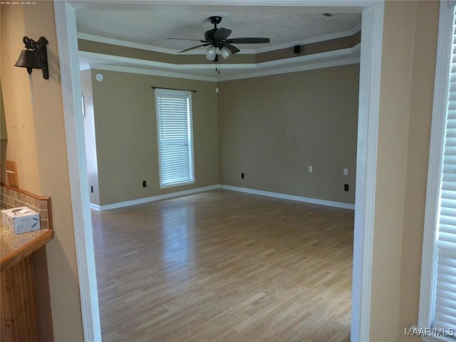 213 Foxdale Rd, Millbrook, AL 36054 - unfurnished room with light wood-style flooring, a ceiling fan, crown molding, and a raised ceiling