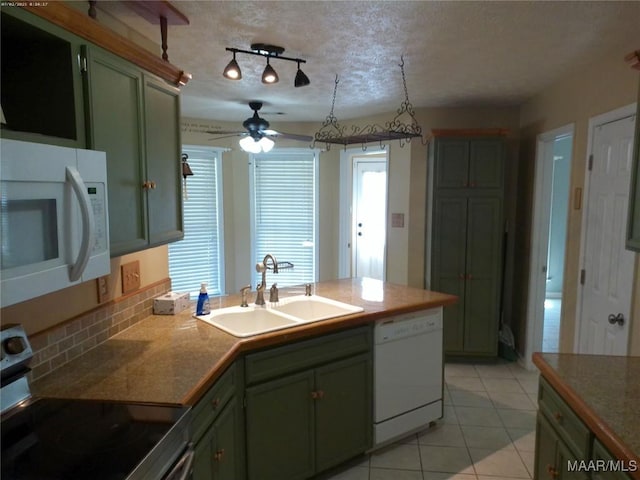 213 Foxdale Rd, Millbrook, AL 36054 - kitchen with white appliances, green cabinetry, ceiling fan, light tile patterned floors, and a peninsula