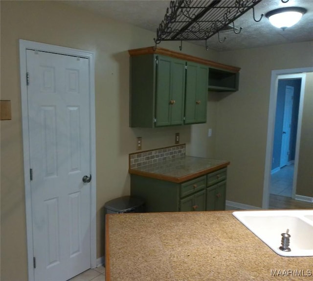 213 Foxdale Rd, Millbrook, AL 36054 - kitchen with green cabinets and light tile patterned floors