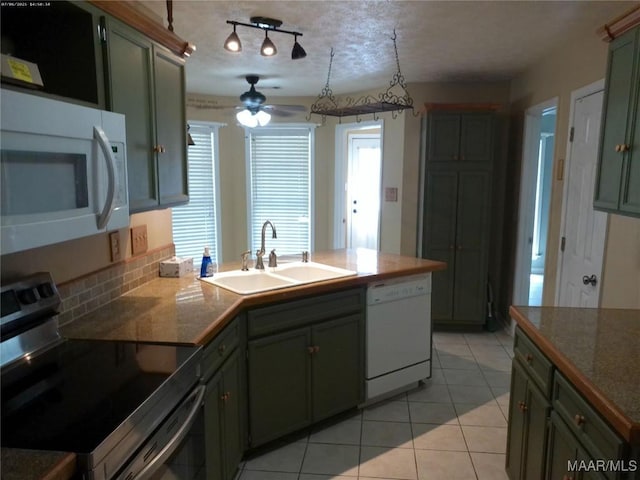213 Foxdale Rd, Millbrook, AL 36054 - kitchen with white appliances, a ceiling fan, a peninsula, light tile patterned floors, and green cabinets