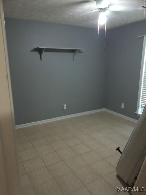 213 Foxdale Rd, Millbrook, AL 36054 - empty room with light tile patterned floors and a ceiling fan